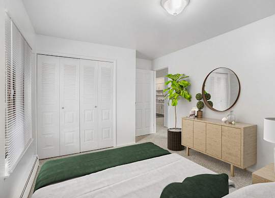An upgraded bedroom with a green bedspread and a large closet at Wingate Apartments, Michigan