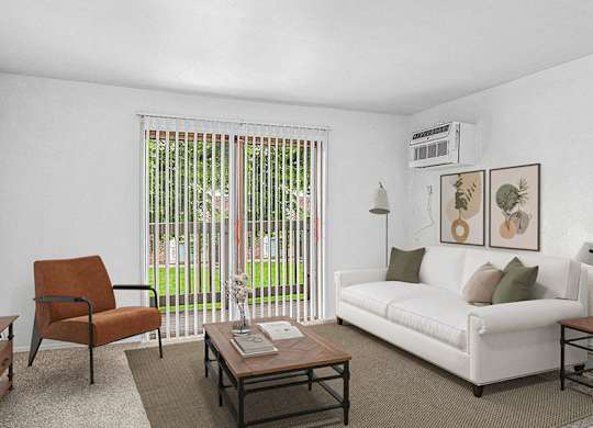 A living room with a white couch, a brown chair, and a coffee table at Wingate Apartments, Michigan