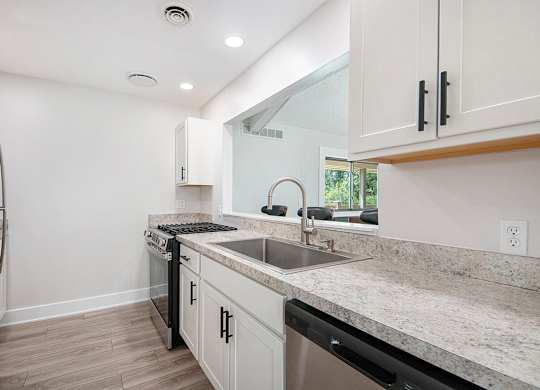 A modern kitchen with stainless steel appliances at Wingate Apartments, Kentwood