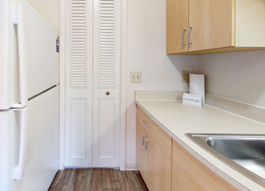 a kitchen with maple cabinetry  at Wood Creek Apartments, Kenosha, 53144
