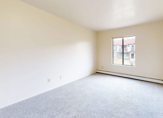 bedroom with carpet and a large window  at Wood Creek Apartments, Wisconsin