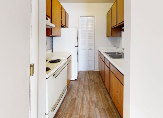 a kitchen with hard-surface floors and white appliances  at Wood Creek Apartments, Kenosha, 53144