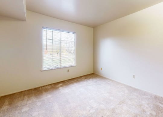 a large bedroom with carpet and a window  at Wood Creek Apartments, Kenosha, WI, 53144