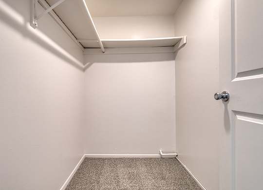 A large bedroom with a carpeted floor at Wood Creek Apartments, Kenosha