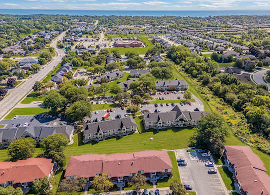 A bird's eye view of a community with buildings and grassy areas at Wood Creek Apartments, Wisconsin
