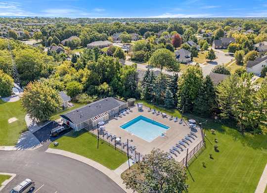 A bird's eye view of an apartment community with a swimming pool at Wood Creek Apartments, Wisconsin