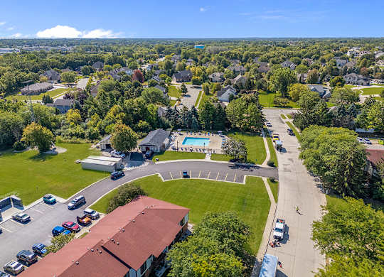 A sunny day in an apartment community with a swimming pool at Wood Creek Apartments, Wisconsin