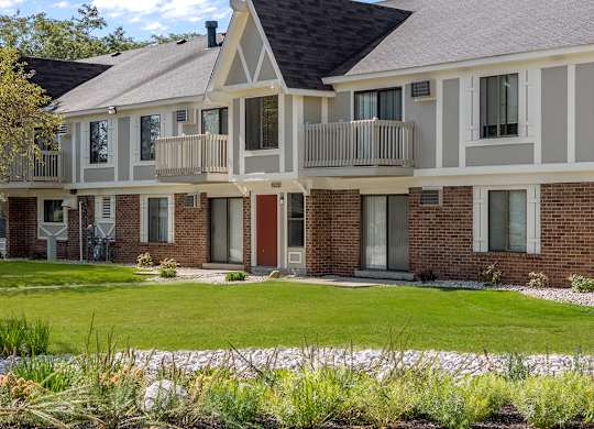 An exterior apartment building with a balconies on the second floor at Wood Creek Apartments, Wisconsin
