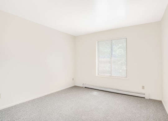 Bedroom with Large Window Private Balcony at Wood Creek Apartments in Kenosha, WI