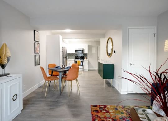 A dining room with a table and chairs.