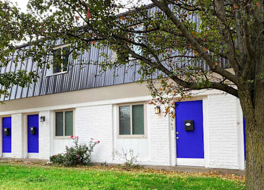 A white house with blue doors and windows.
