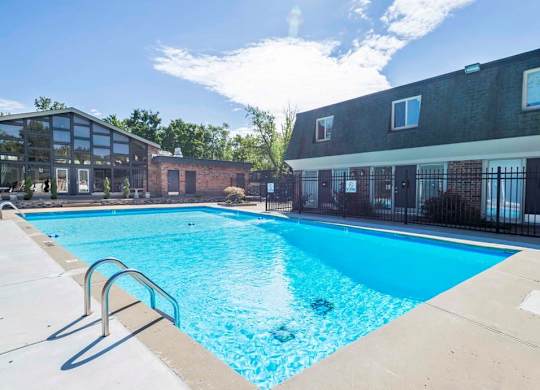 A large swimming pool in front of a building.