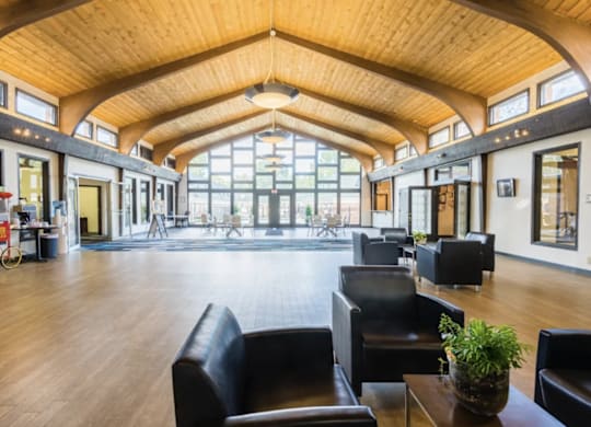 A large room with a high ceiling and wooden floors.