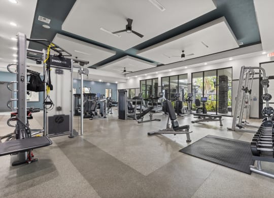 Gym with weights and cardio equipment with glass doors at Pearce at Pavilion Luxury Apartments, Riverview, FL