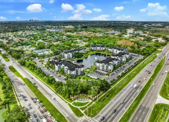Aerial view of a city with a pond and cars on the road at Pearce at Pavilion Luxury Apartments, Riverview