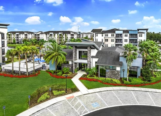 an aerial view of the property with palm trees and other buildings at Pearce at Pavilion Luxury Apartments, Riverview, FL, 33578