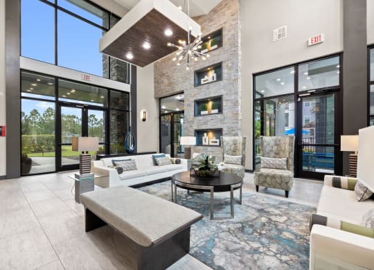 a living room with couches and chairs and a fireplace at Pavilion Luxury Apartments, Riverview, FL, Florida