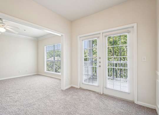 Living and dining room with carpeted floor, and windows