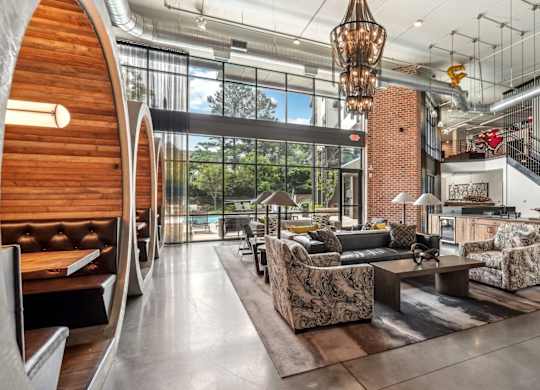 Resident clubhouse with many seating areas with couches, work booths, and chairs