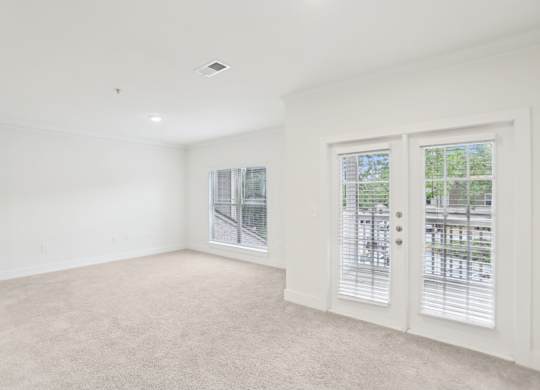 Spacious living room with big windows and natural light