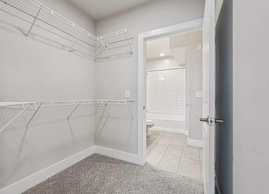 A super large spacious closet. a large, high ceiling, apartment that has two floors, is a modern loft, and in atlanta