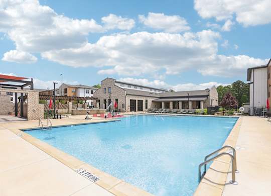 A large swimming pool with many lounge seats and areas