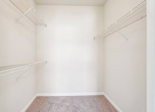 A large walk-in closet with shelves.