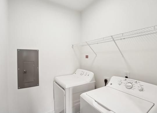 A white washing machine and dryer in a laundry room.