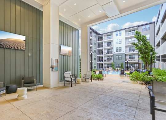 A modern building lobby with a green wall and a large painting.