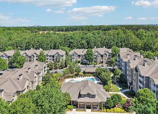 A bird's eye view of a residential area and a swimming pool.