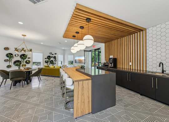 A modern kitchen with a wooden ceiling and a patterned floor.