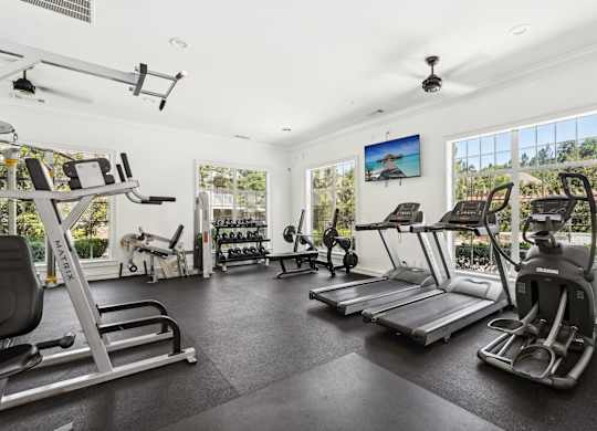 A spacious gym with a variety of exercise equipment.