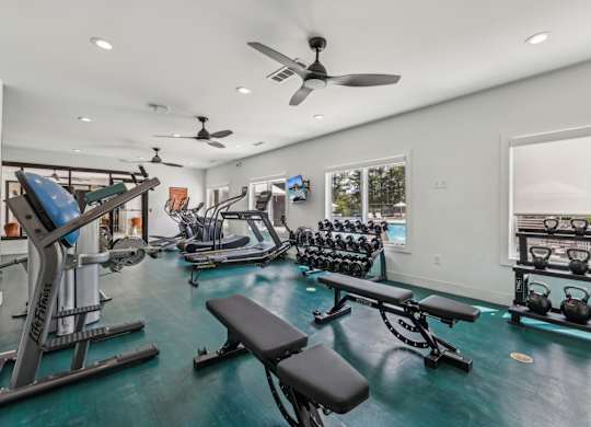 A well-equipped home gym with a variety of exercise equipment.