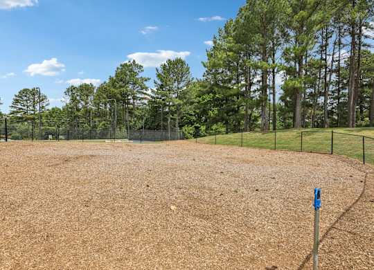 fenced in dog park. with water fountain