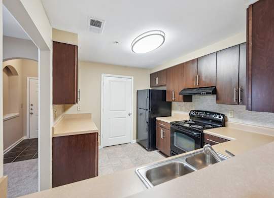 A kitchen with a stove, oven, and sink.