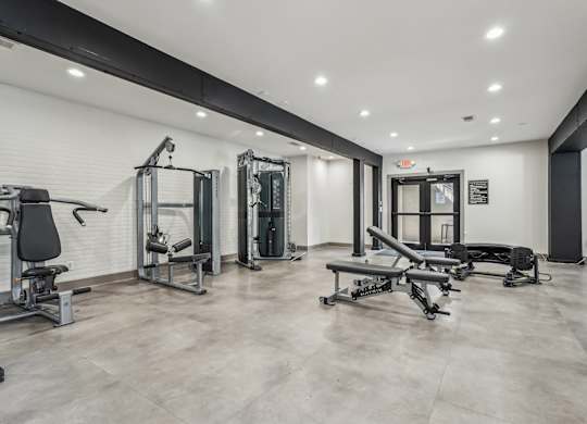 A spacious gym with various exercise equipment.