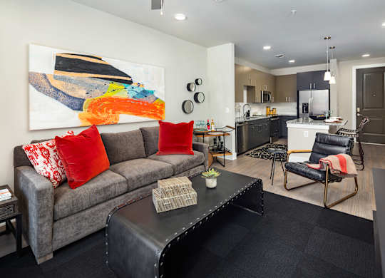 A modern living room with a view of the kitchen