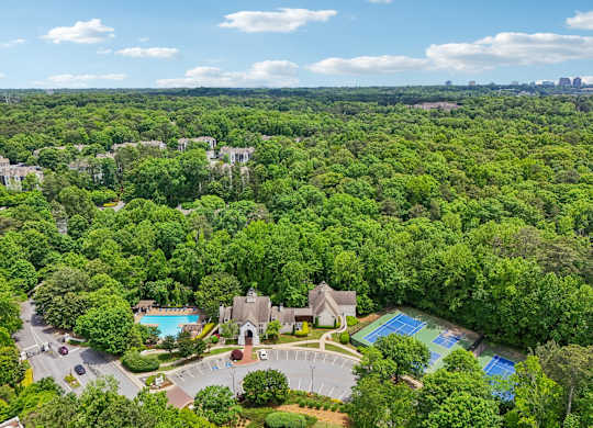 A bird's eye view of community with a swimming pool and tennis court.