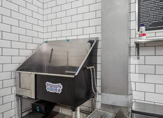 An enclosed stainless steel bathing tub for dogs or pets. Petspa