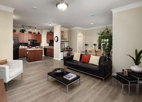 A living room with a black couch and a coffee table.