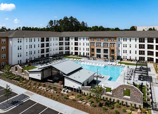 A large building with a pool in front of it.