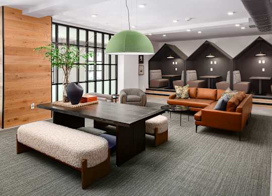 resident lounge set up with coworking spaces and a cozy lounge to hang out