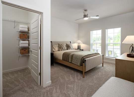 bedroom with guaranteed ceiling fan, walk-in closet, natural lighting, and tons of space for activities