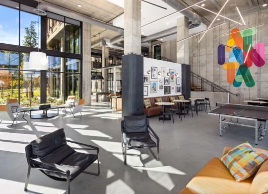the lobby of a building with a ping pong table and chairs