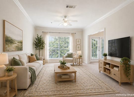 A living room with a couch, a coffee table, a television, and a painting on the wall.