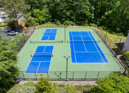 an aerial view of a tennis court with two blue tennis