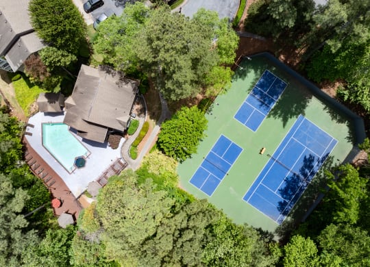 arial view of a house with a tennis court and a pool
