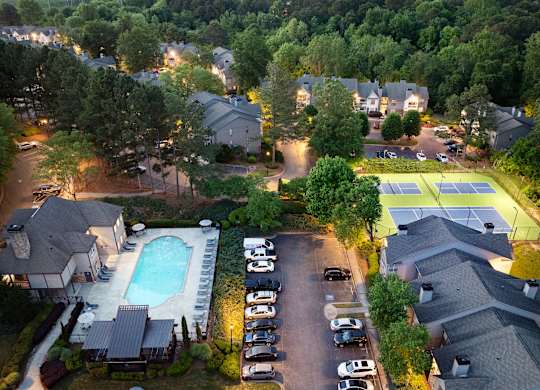 A residential area with houses, a swimming pool, and tennis courts.