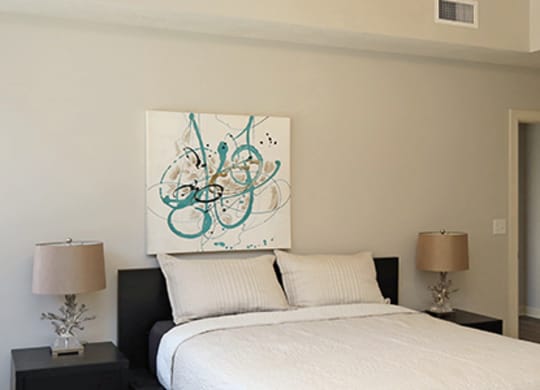 a bedroom with a bed and a large window