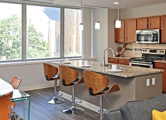 a kitchen and dining room with stainless steel appliances and a large window